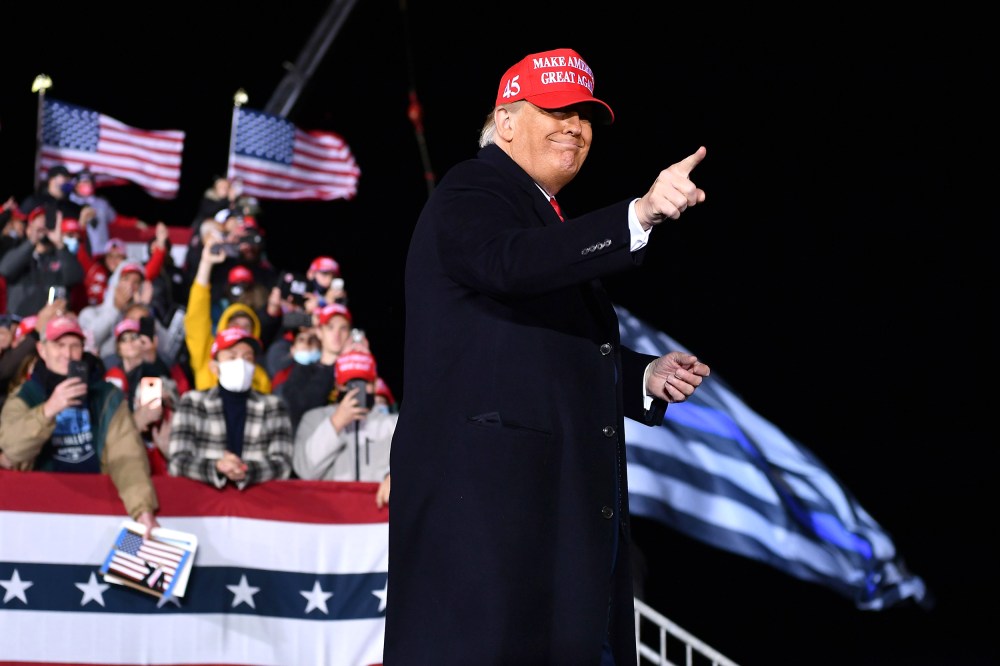 US President Donald Trump gestures during a rally at Southern Wisconsin Regional Airport in Janesville, Wisconsin on October 17, 2020.