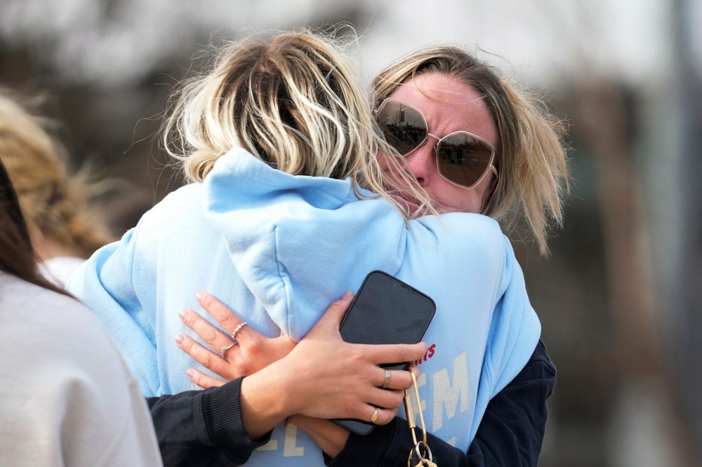 Students hug on the Michigan State University campus in East Lansing, Mich.