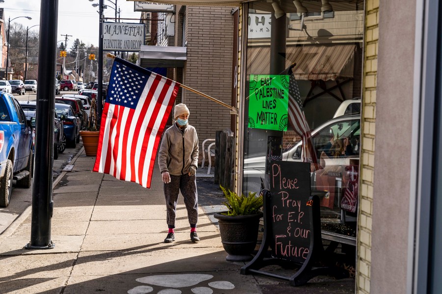Image: A resident walks by an American flag on N. Market Street on Feb. 23, 2023 in East Palestine, Ohio.