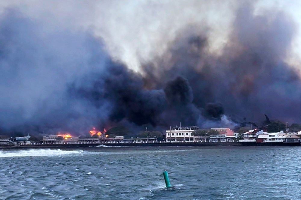In this photo provided by Brantin Stevens smoke fill the air from wild fires at Lahaina harbor on Tuesday, Aug. 8, 2023 in Hawaii. Fire was widespread in Lahaina Town, including on Front Street, a popular shopping and dining area, County of Maui spokesperson Mahina Martin said by phone early Wednesday. Traffic has been very heavy as people try to evacuate the area, and officials asked people who weren’t in an evacuation area to shelter in place to avoid adding to the traffic, she said.
