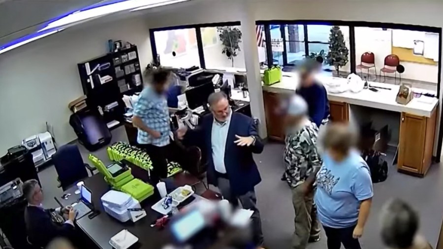 Scott Hall, an Atlanta-area Trump supporter and bail bondsman, center, inside a Coffee County elections office in rural Georgia on Jan. 7, 2021. 