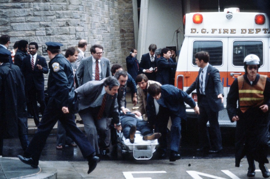 White House Press Secretary James Brady is carried to an ambulance.
