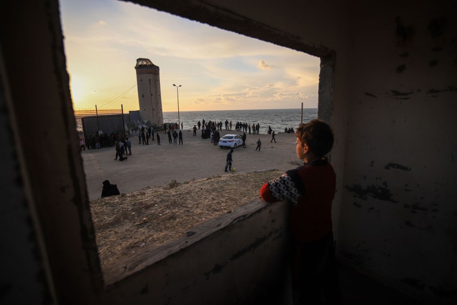 Displaced Palestinians beside the border wall with Egypt and sea in Rafah, Gaza Strip, on Feb. 1, 2024. 