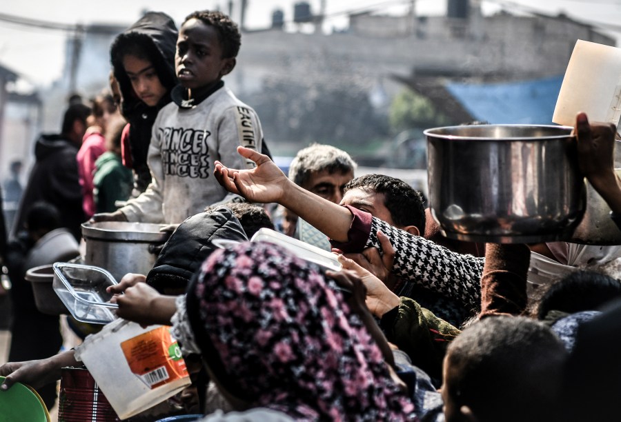 Palestinians wait long queues for food in Rafah