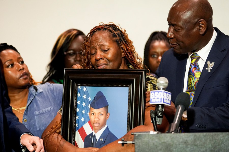 Chantemekki Fortson, mother of Roger Fortson, holds a photo of her son.