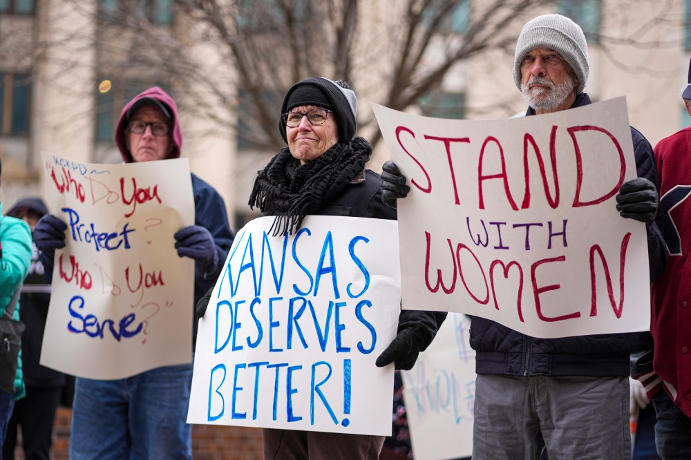 People with signs outside courthouse.