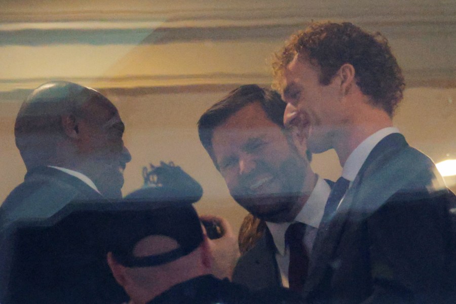 JD Vance and Daniel Penny smile at the game