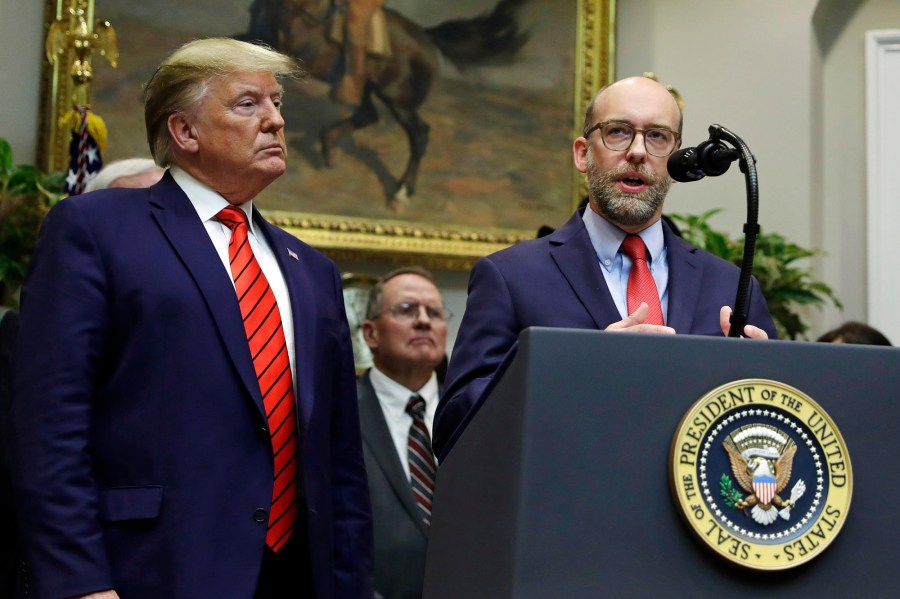 President Donald Trump listens as acting director of the Office of Management and Budget Russ Vought speaks at the White House in 2019.