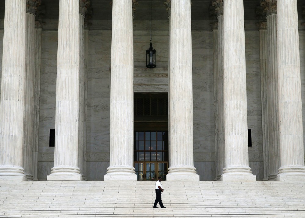 A guard stands outside the U.S. Supreme Court , on June 9, 2014 in Washington, DC.