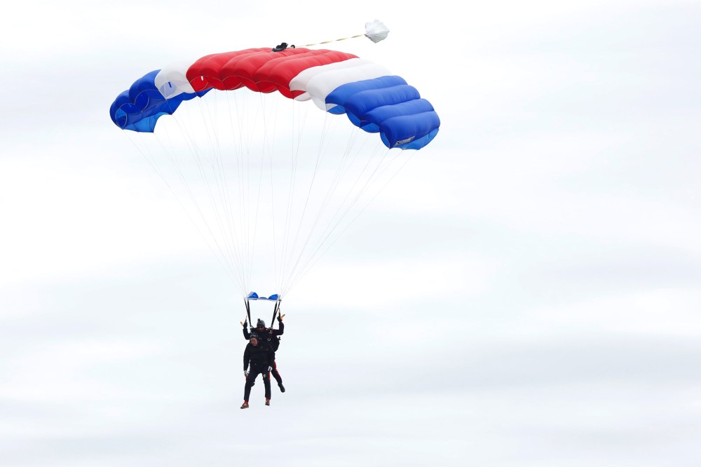 Former U.S. President George H.W. Bush and Mike Elliott, US Army Sergeant 1st Class (ret), jump out of a helicopter and parachutes down to St. Anne's Episcopal Church on June 12, 2014 in Kennebunkport, Maine.
