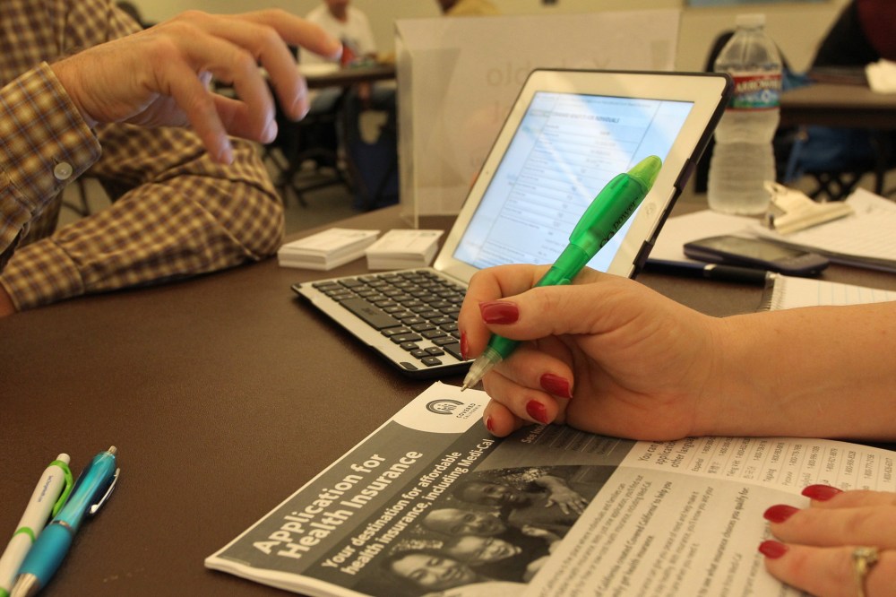 A healthcare reform specialist helps people select insurance plans at the free Affordable Care Act (ACA) Enrollment Fair at Pasadena City College on November 19, 2013 in Pasadena, California.