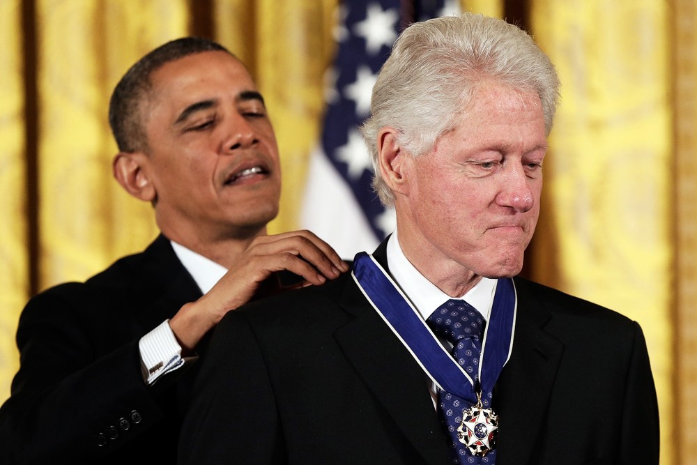 U.S. President Barack Obama awards the Medal of Freedom to former U.S. President Bill Clinton at the White House, Nov. 20, 2013.