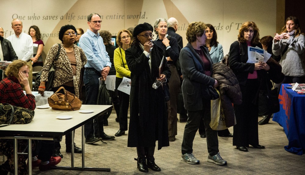 Job seekers speak to potential employers at a jobs fair for people 50-years-old and older on November 20, 2013 in New York City.