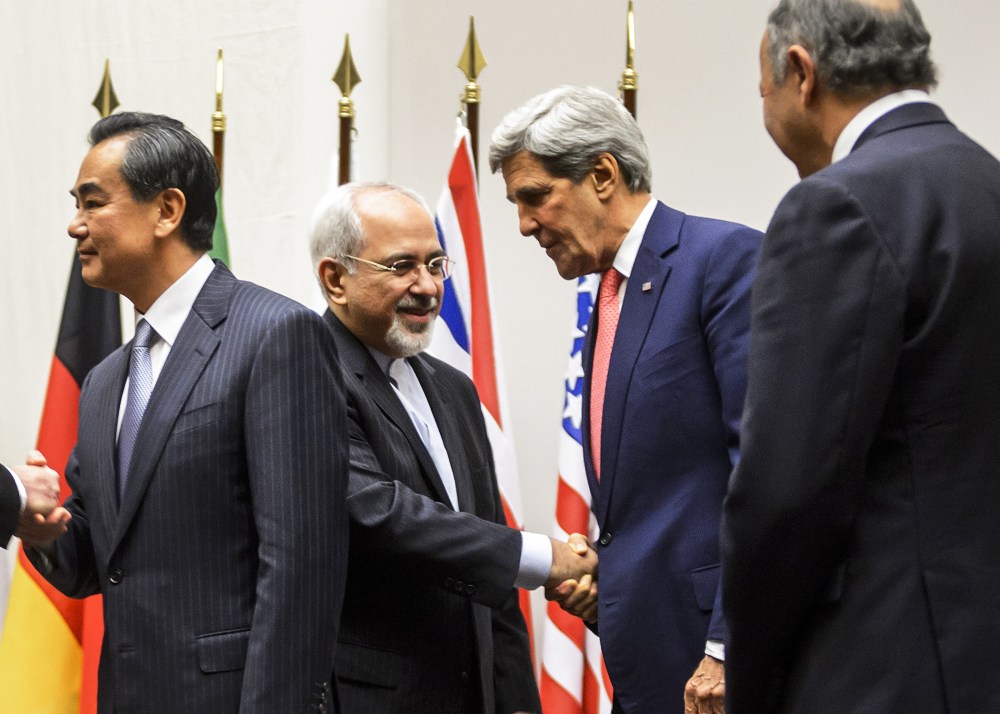 Iranian Foreign Minister Mohammad Javad Zarif shakes hands with US Secretary of State John Kerry, Nov. 24, 2013.