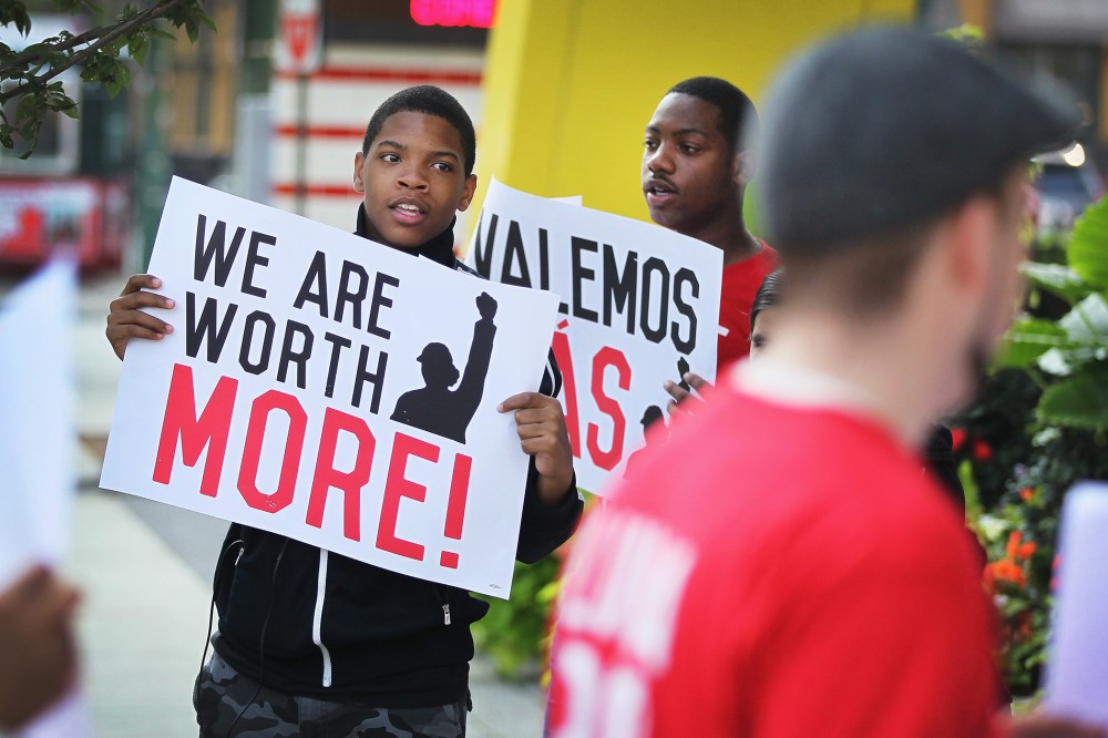 Fast food workers and activists demonstrate outside McDonald's downtown flagship restaurant on July 31, 2014 in Chicago, Illinois.