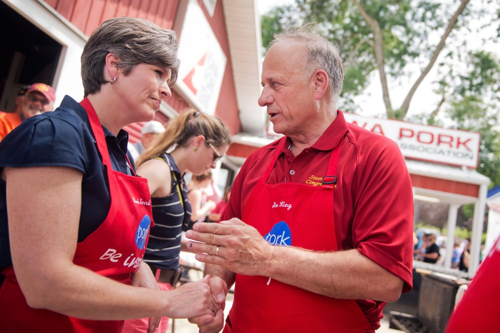 Joni Ernst, center, Iowa Republican Senate candidate, and Rep. Steve King, R-Iowa, talk in the Pork Tent at the 2014 Iowa State Fair in Des Moines, Iowa, Aug. 8, 2014.