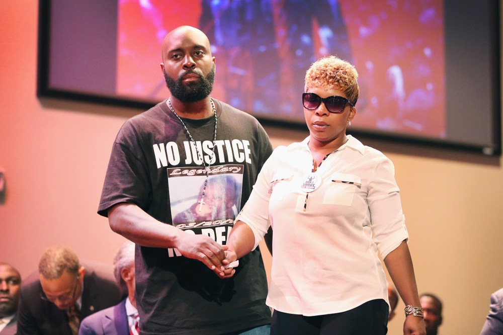 Michael Brown Sr. and Lesley McSpadden, the parents of slain teenager Michael Brown, attend a rally at Greater Grace Church on Aug. 17, 2014 in Ferguson, Mo. (Photo by Scott Olson/Getty)