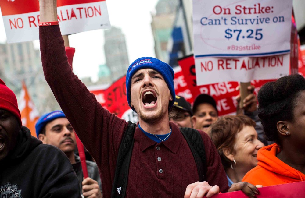 Protesters rally outside of a Wendy's in support of raising fast food wages in Brooklyn, New York, Dec. 5, 2013.