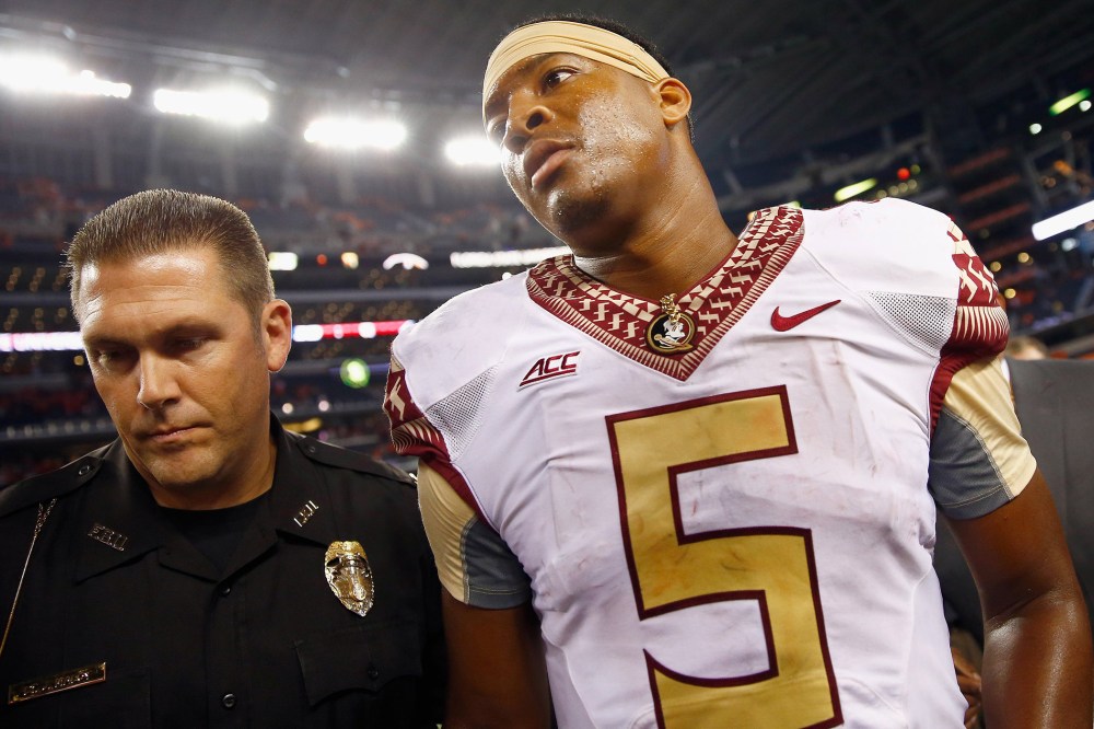 Jameis Winston of the Florida State Seminoles walks off the field after a game at AT&T Stadium on Aug. 30, 2014 in Arlington, Texas. Photo by Tom Pennington/Getty