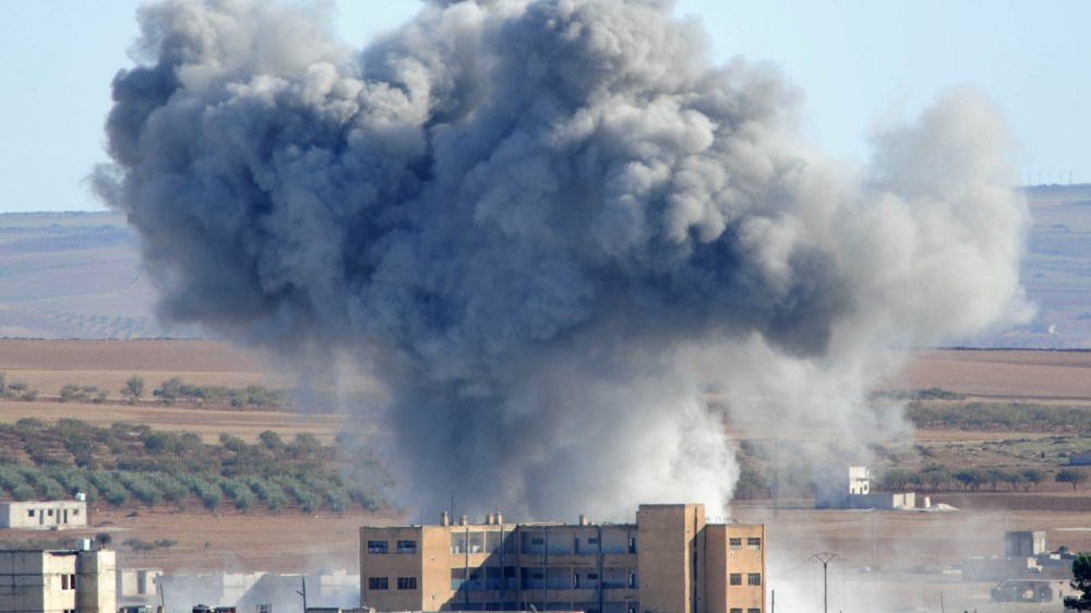 Heavy smoke from an airstrike by the U.S.-led coalition planes rises in Kobani, Syria, on Oct. 20, 2014. (Gokhan Sahin/Getty)