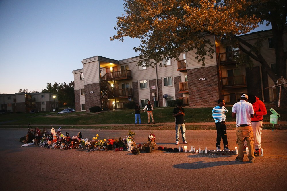 Neighborhood residents hang out at a memorial for 18-year-old Michael Brown on Canfield Street on Oct. 20, 2014 in Ferguson, Mo. (Photo by Scott Olson/Getty)