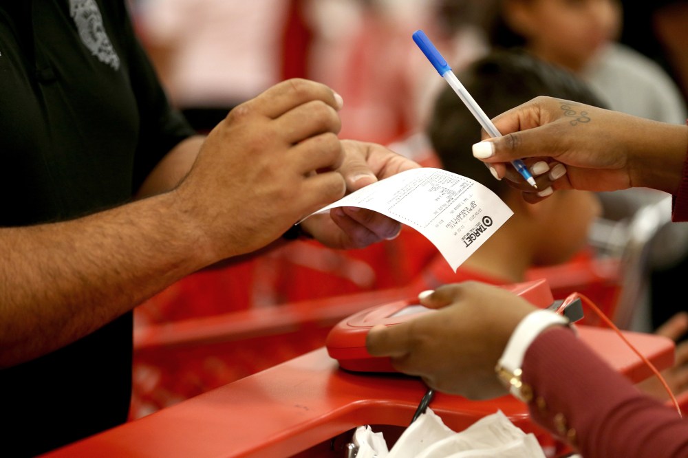 A customer prepares to sign a credit card slip at a Target store on Dec. 19, 2013 in Miami, Fla.