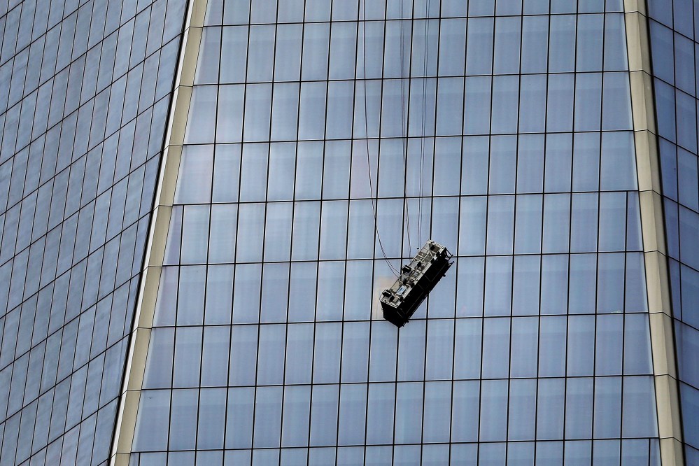 A scaffold carrying two workers hangs 69 floors up at One World Trade Center on Nov. 12, 2014 in New York City.