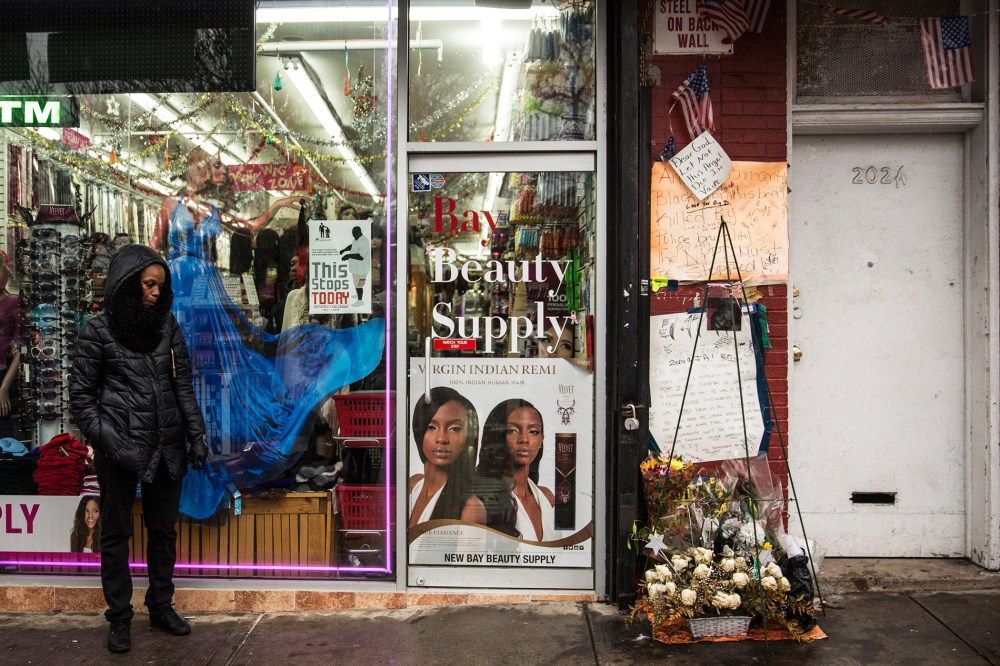 People stand around outside the beauty salon where Eric Garner was killed on July 17, Dec. 3, 2014 in the Staten Island borough of New York, N.Y. (Photo by Andrew Burton/Getty)