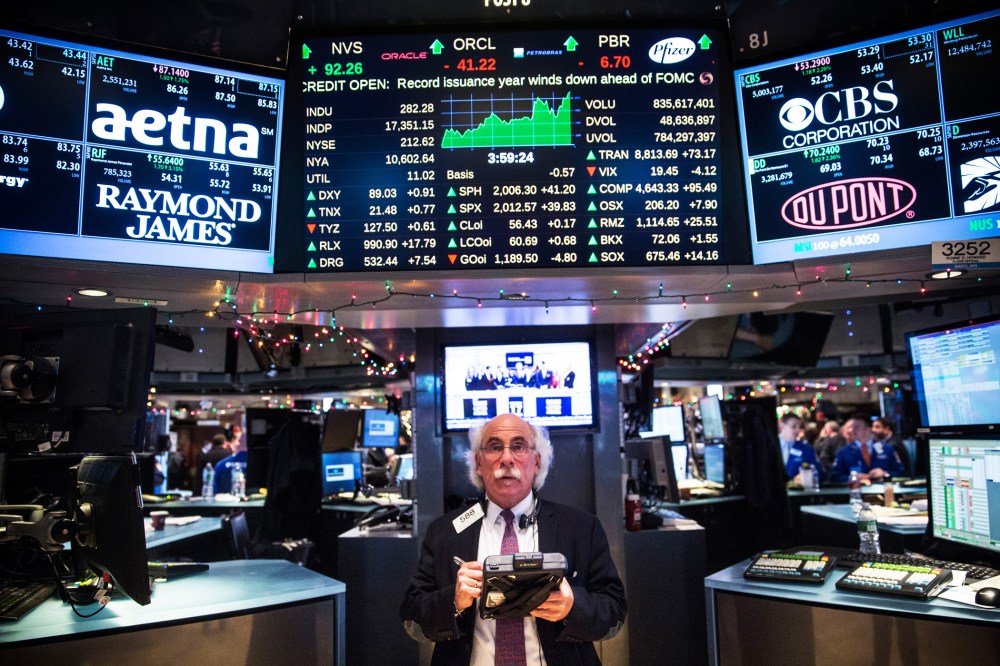 A trader works on the floor of the New York Stock Exchange during the afternoon of Dec. 17, 2014 in New York, N.Y. (Photo by Andrew Burton/Getty)