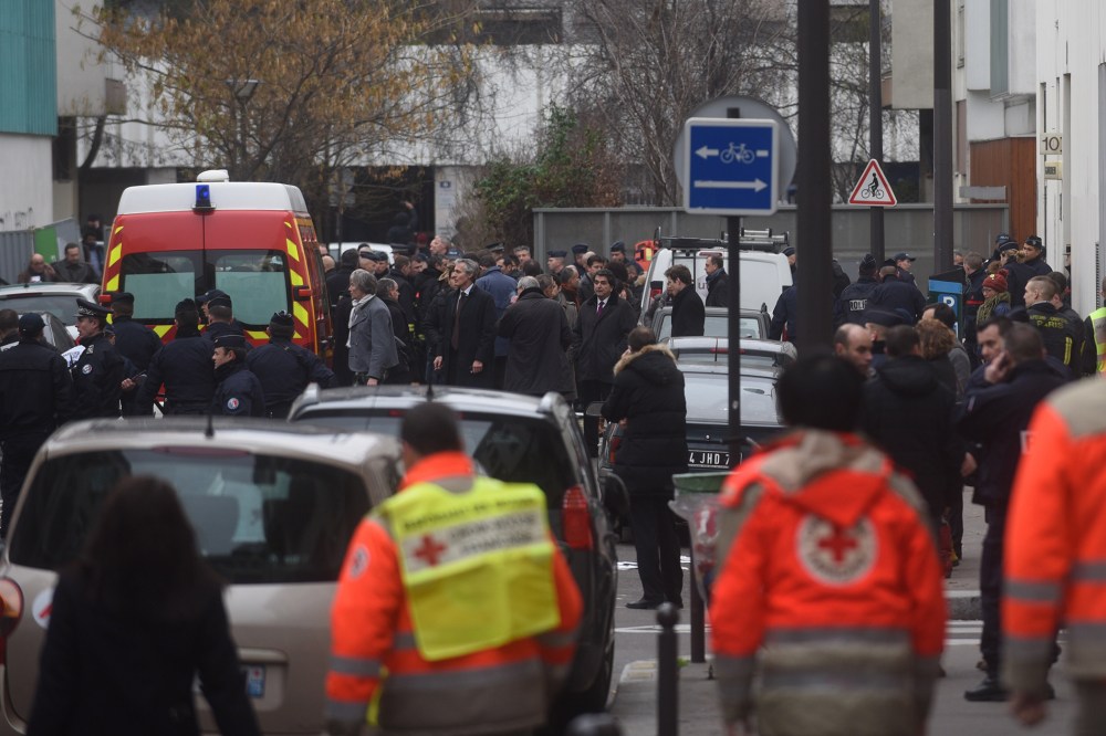 Ambulances and police officers gather in front of the offices of the French satirical newspaper Charlie Hebdo on Jan. 7, 2015 in Paris, France.