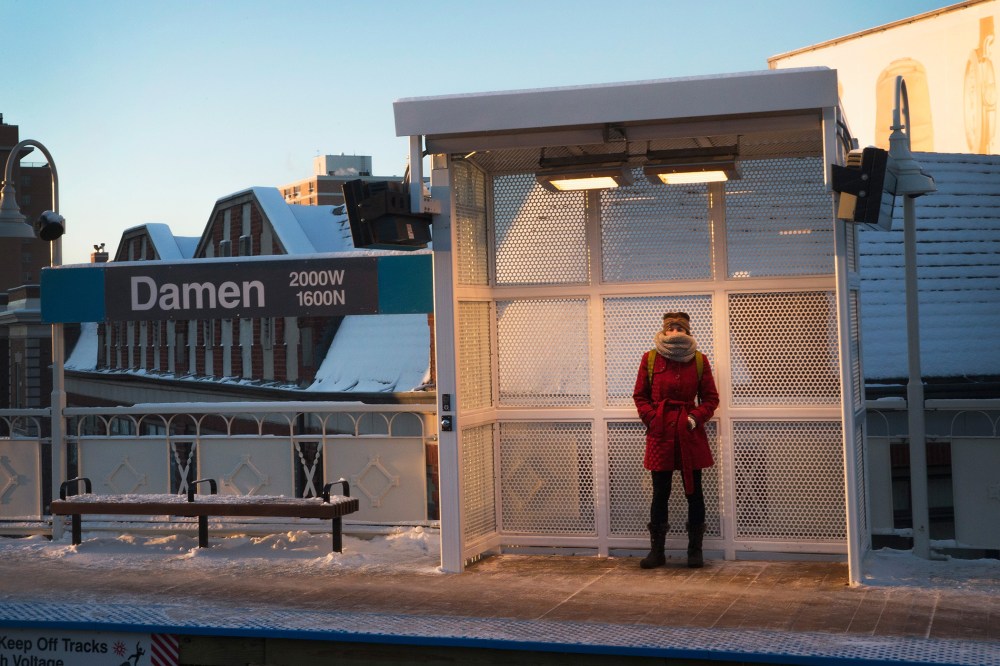A woman tries to stay warm as she waits for a train on an L platform during the morning rush while temperatures hovered around zero degrees Fahrenheit on January 7, 2015 in Chicago, Illinois. (Photo by Scott Olson/Getty)