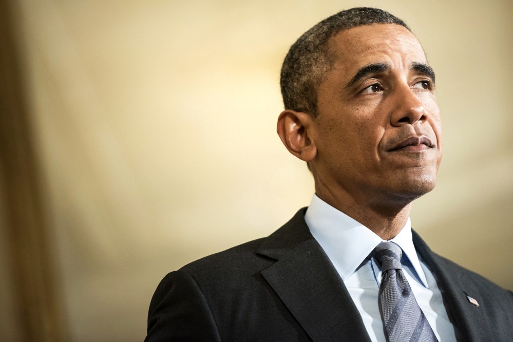 President Barack Obama pauses while speaking during an event in the East Room of the White House's private dining room Jan. 9, 2014 in Washington, D.C. (Photo by Brendan Smialowski/AFP/Getty)