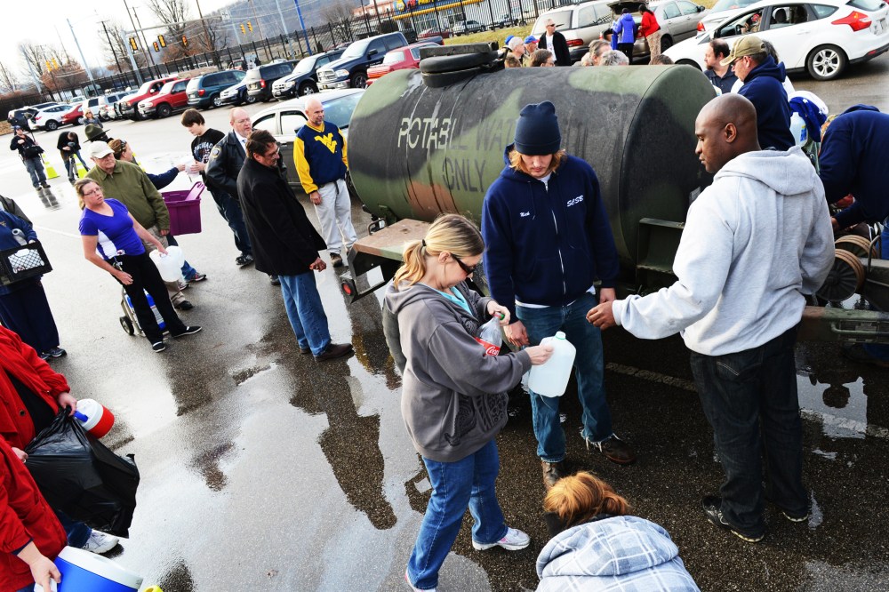 West Virginia American Water customers line up for water at the Gestamp Plant in South Charleston, West Virginia, Jan. 10, 2014.