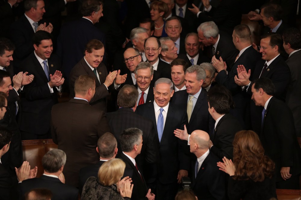 Israeli Prime Minister Benjamin Netanyahu is greeted by members of Congress as he arrives to speak during a joint meeting of the United States Congress at the Capitol March 3, 2015 in Washington, DC. (Photo by Chip Somodevilla/Getty)