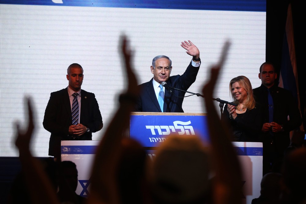 Israeli Prime Minister Benjamin Netanyahu (C) delivers a speech next to his wife Sara as he reacts to exit poll figures in Israel's parliamentary elections late on March 17, 2015 in Tel Aviv, Israel. (Photo by Menahem Kahana/AFP/Getty)