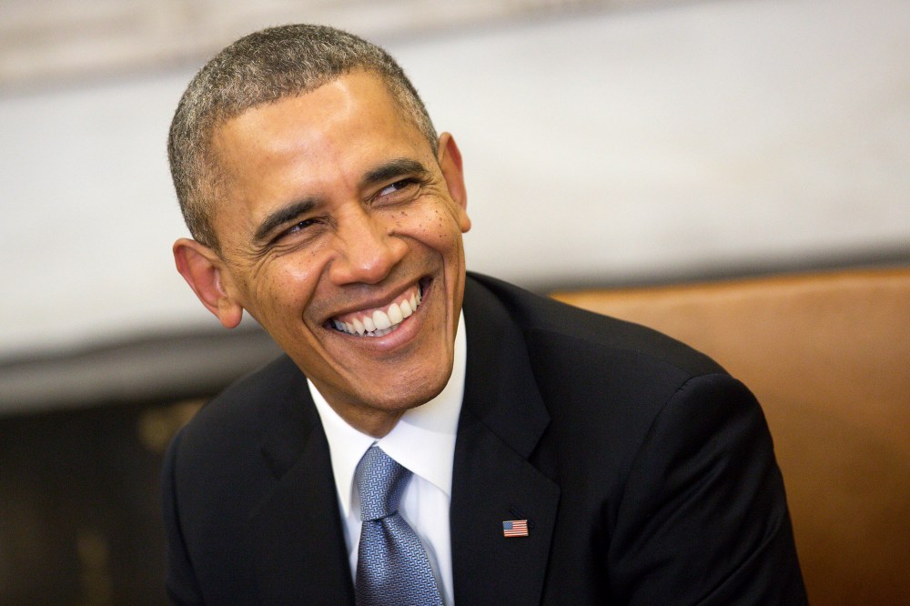 President Barack Obama smiles in the Oval Office at the White House on Feb. 11, 2014 in Washington, D.C. (Photo by Andrew Harrer/Pool/Getty)