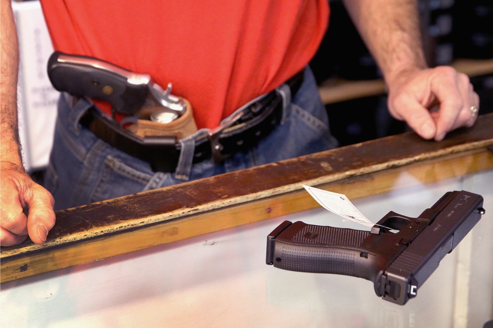Dan Egar helps a customer shop for a handgun on February 13, 2014 in Tinley Park, Illinois.
