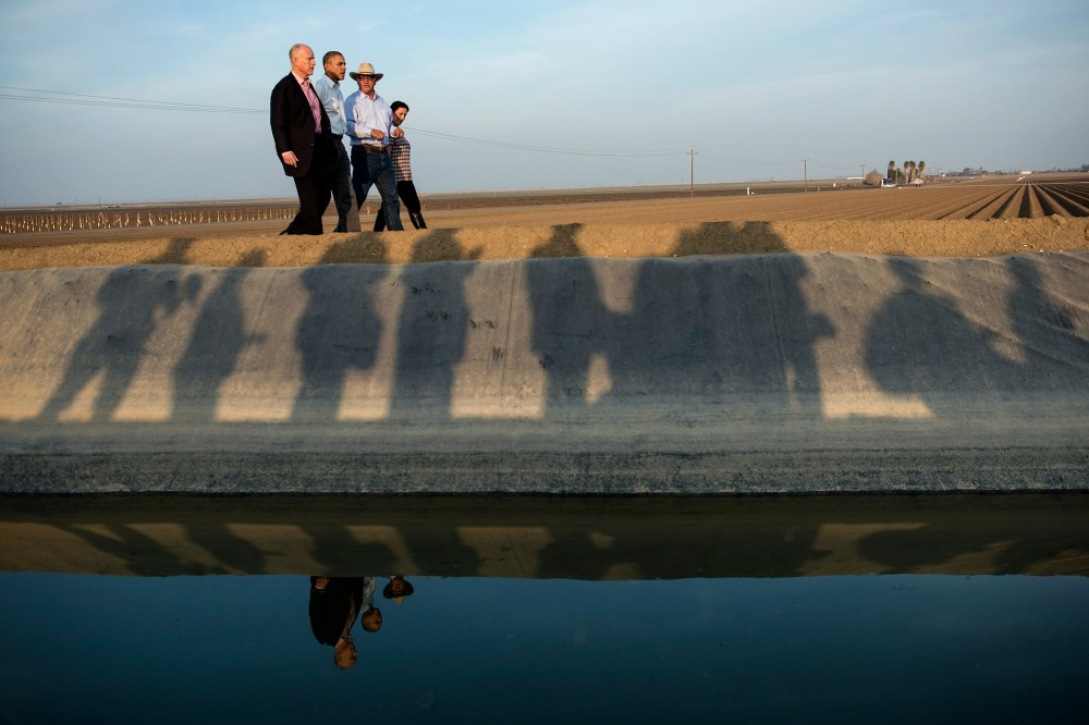 From left, California Governor Jerry Brown and President Barack Obama are lead on a tour of Empresas Del Bosque, Inc.'s farm by Joe Del Bosque and Maria Gloria Del Bosque, Feb. 14, 2014 in Los Banos, Calif.