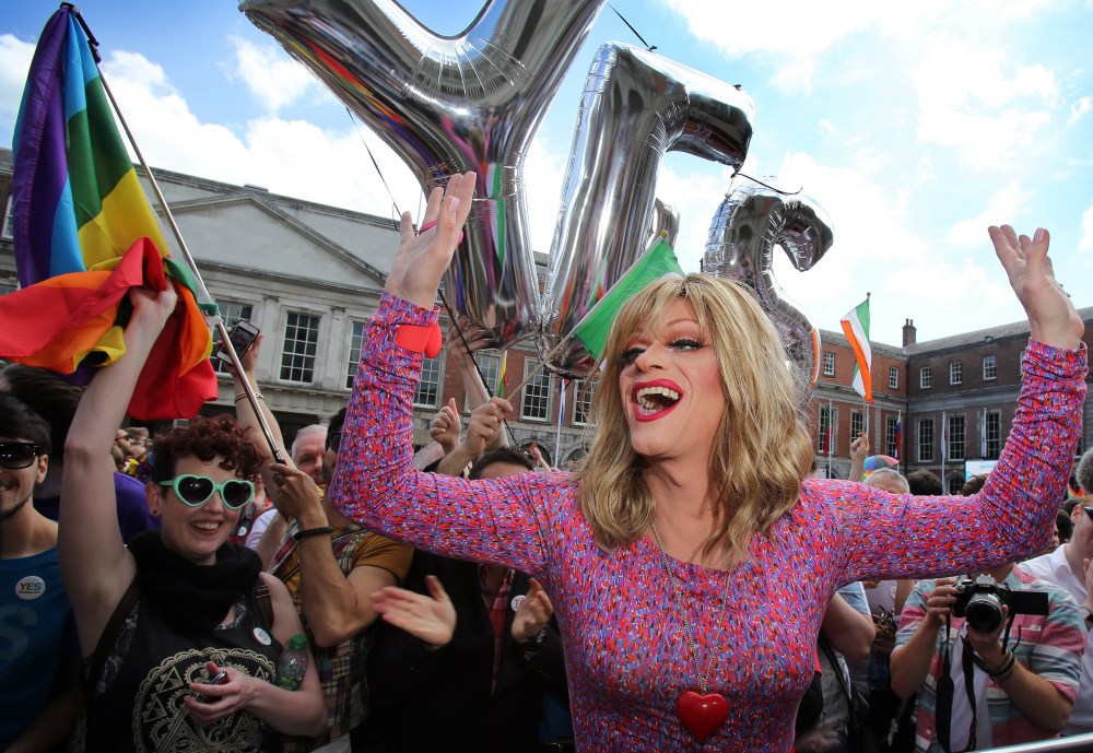 Drag queen and gay rights activist, Rory O'Neill, also known by his stage name Panti raises her arms by supporters for same-sex marriage at Dublin Castle as they wait for the result of the referendum on May 23, 2015. (Photo by Paul Faith/AFP/Getty)