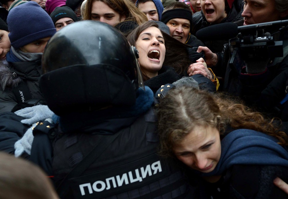 Nadezhda Tolokonnikova (rear) and Maria Alyokhina (front) are taken into custody by Russian police during a protest on Feb. 24, 2014.