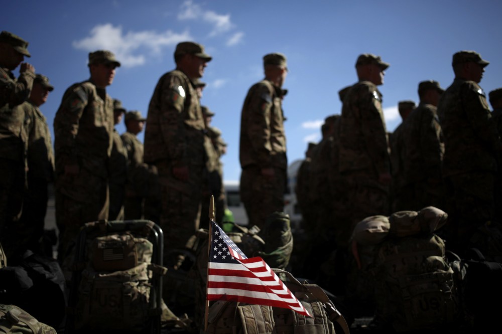 An American flag flies from the rucksack of a soldier outside a homecoming ceremony at Fort Knox on  Feb. 27, 2014 in Fort Knox, Ky.