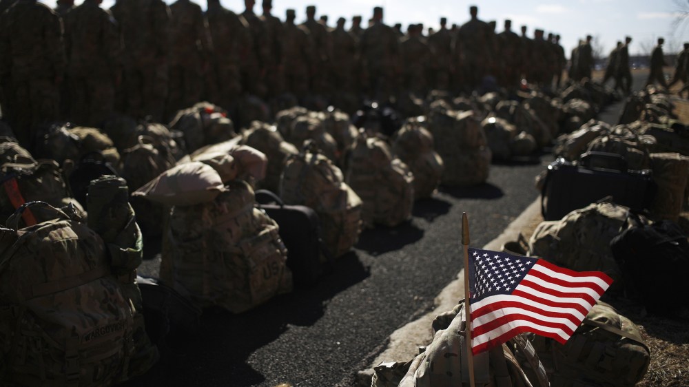 An American flag flies from the rucksack of soldier outside a homecoming ceremony on Fort Knox on Thursday, February 27, 2014 in Fort Knox, Ky.