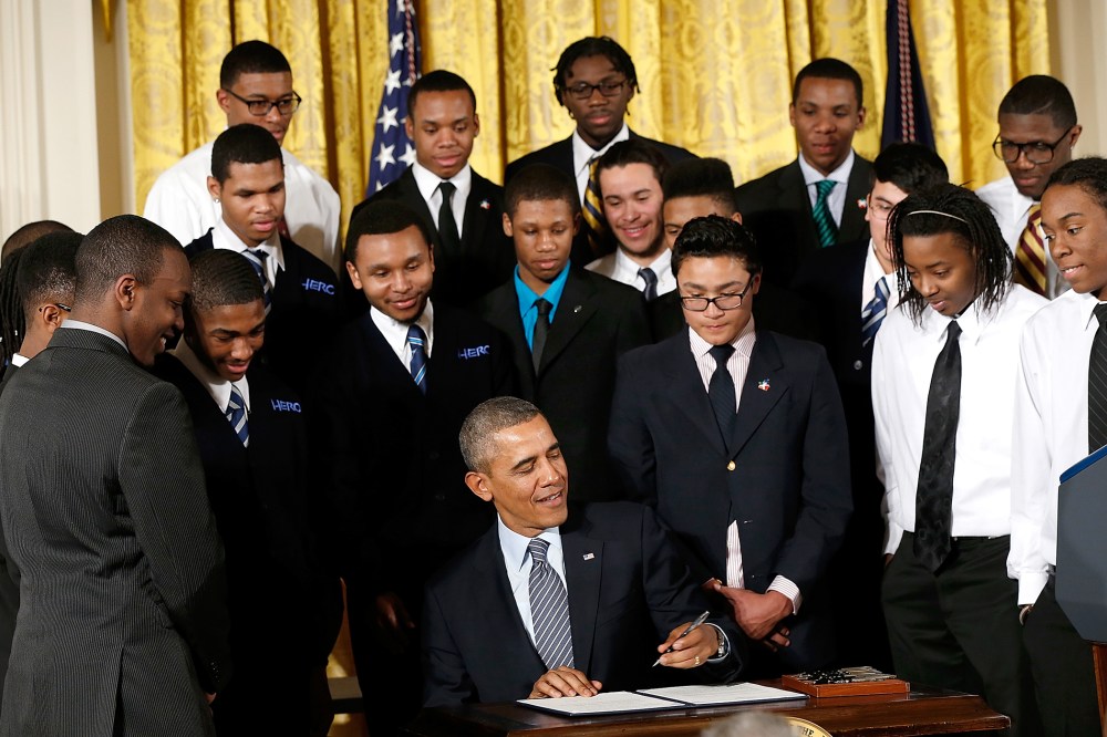 U.S. President Barack Obama signs an executive memorandum regarding the My Brother's Keeper Initiative, Feb. 27, 2014.