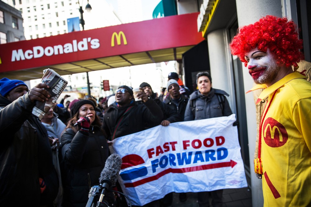 A man dressed as the McDonald's mascot participates in a protest for higher wages for fast food workers on March 18, 2014 in New York City.