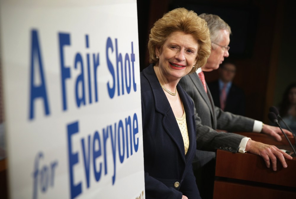 Sen. Debbie Stabenow (D-MI) looks at a poster during a news conference March 26, 2014 on Capitol Hill in Washington, D.C.