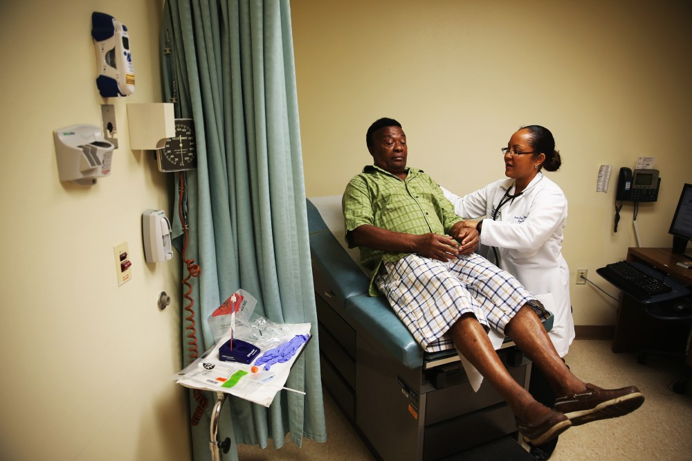 Felue Chang, who is newly insured under an insurance plan through the Affordable Care Act, receives a checkup,  April 15, 2014 in Hollywood, Florida.