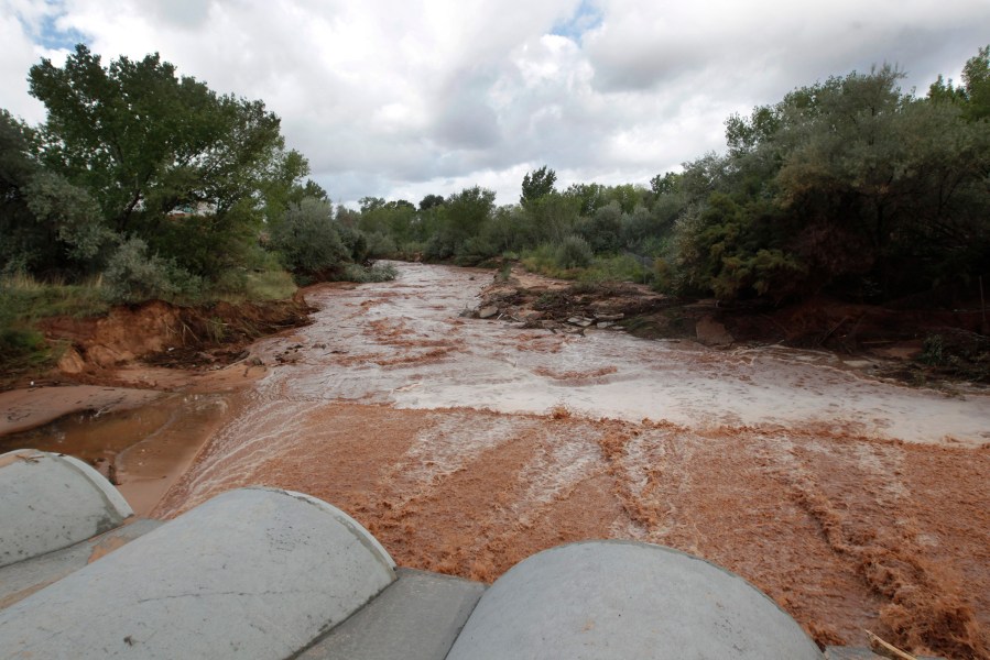 Flood waters flow through pipes down Short Creek on September 15, 2015 in Colorado City, Ariz. (Photo by George Frey/Getty)