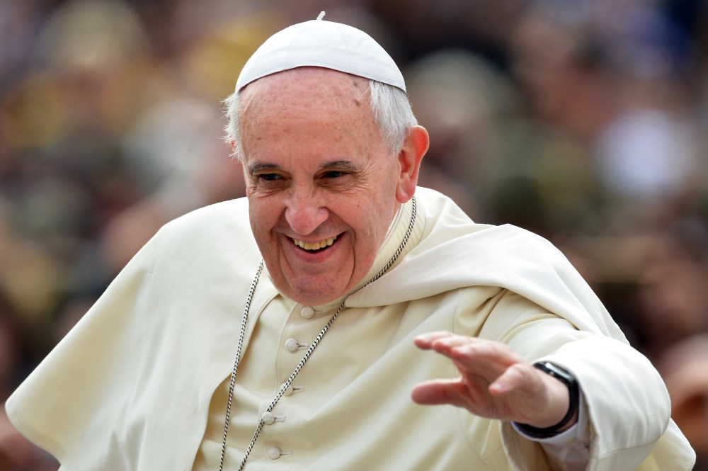 Pope Francis waves to the crowd as he arrives to hold his general audience at St Peter's square, on May 7, 2014 in Vatican city.