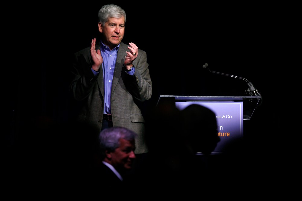 Michigan Governor Rick Snyder applauds during a luncheon May 21, 2014 in Detroit, Michigan. (Photo by Joshua Lott/Getty)