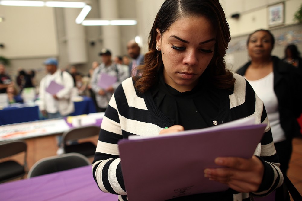 A job seeker fills out an application during a career fair at the Southeast Community Facility Commission on May 21, 2014 in San Francisco, California.